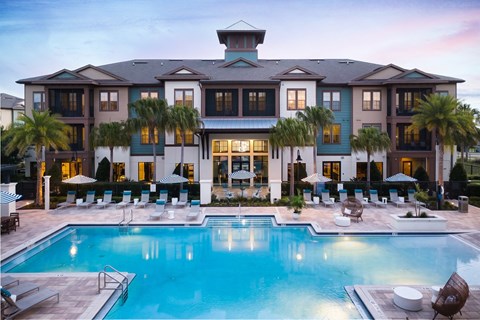 A large house with a pool in front.