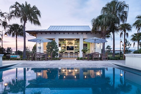 A modern house with a pool in front.