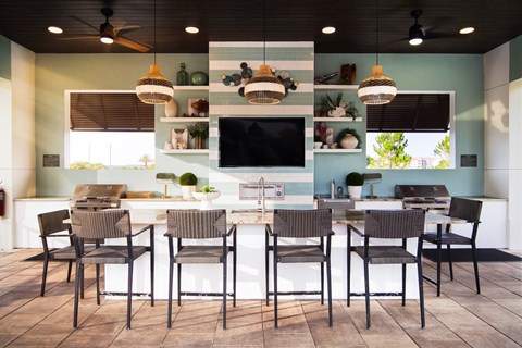 A kitchen with a table and chairs.
