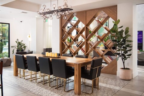 A dining room with a wooden table and chairs.