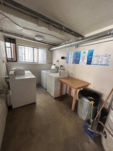 A room with a washing machine and a wash basin.