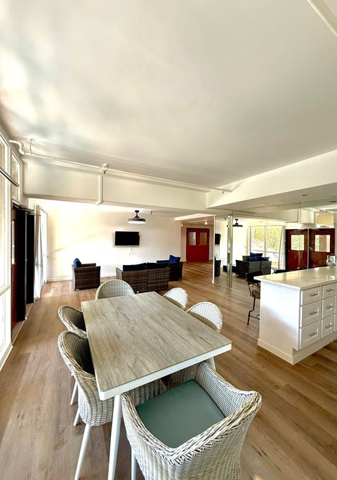 A dining room with a table and chairs.