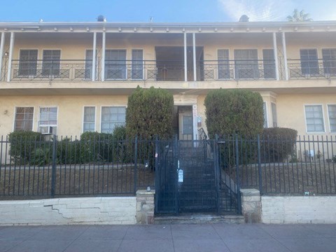 A building with a black gate in front.