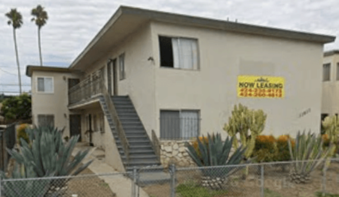 A house with a sign that says "Now Leasing".