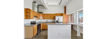 A kitchen with wooden cabinets and a white counter.