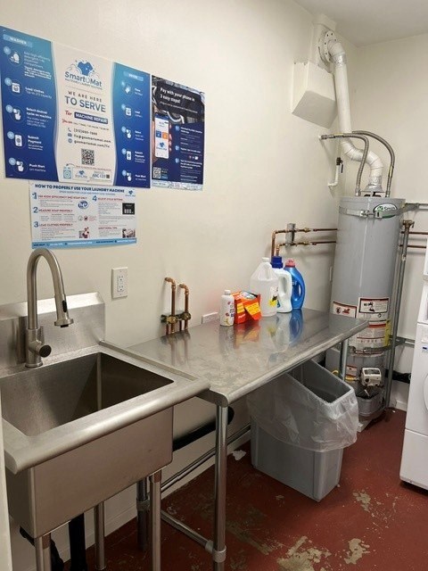 A kitchen with a stainless steel sink and a dishwasher.