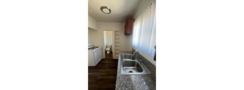 A kitchen with a sink and a stove.