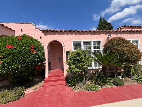 A red building with a red door and steps leading to it.