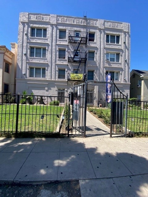 A building with a black gate in front of it.