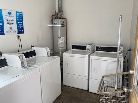 A laundry room with a sign that says SmartMate to serve you.