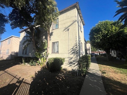 A house with a tree in front of it.