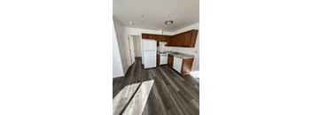 A kitchen with white appliances and wooden cabinets.