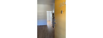 A yellow door with the number 1224 on it.