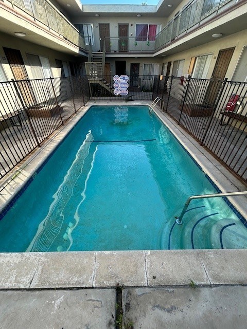 A small pool with a metal fence around it.