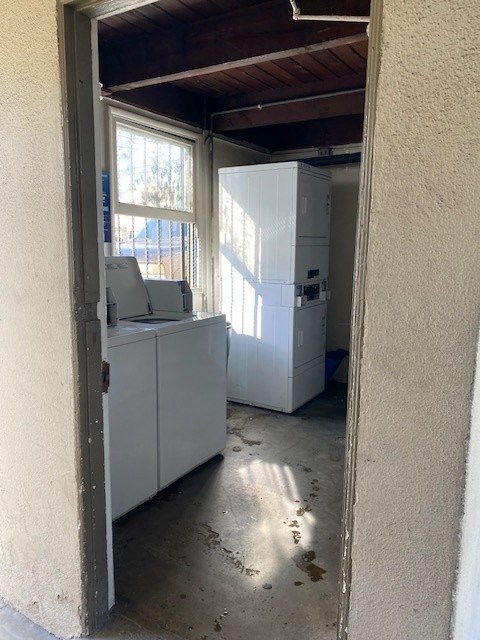 A white fridge and freezer are in a room with a window.