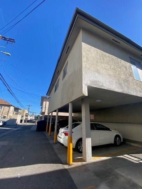 A white car is parked in a parking garage.