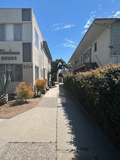 A long, narrow sidewalk runs between two buildings with the name "Bankhouse" on the front.