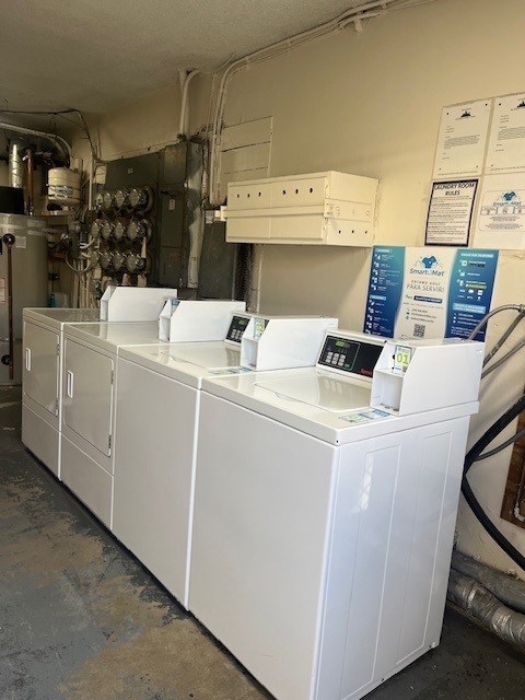 A series of white industrial machines are lined up in a room.