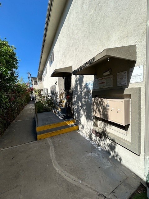 A utility box is on the side of a building.