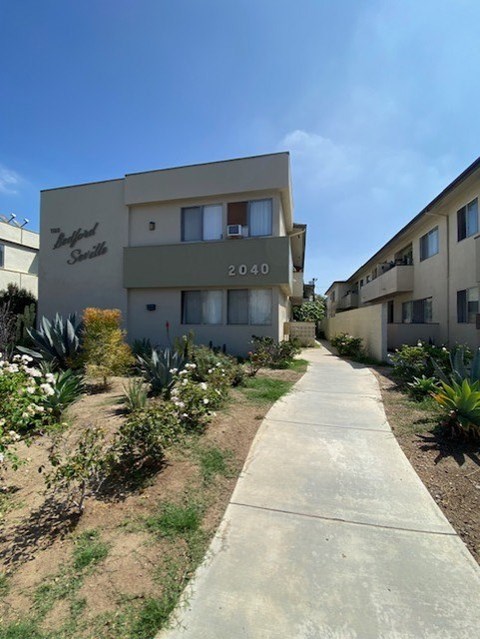 A concrete pathway leads to a building with the number 2040 on it.
