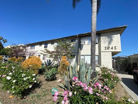 A house numbered 2042 is surrounded by a well-kept garden.