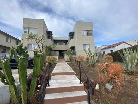 A modern building with a concrete facade and a staircase leading to the entrance.