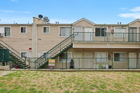 Apartment complex with a green lawn in front.