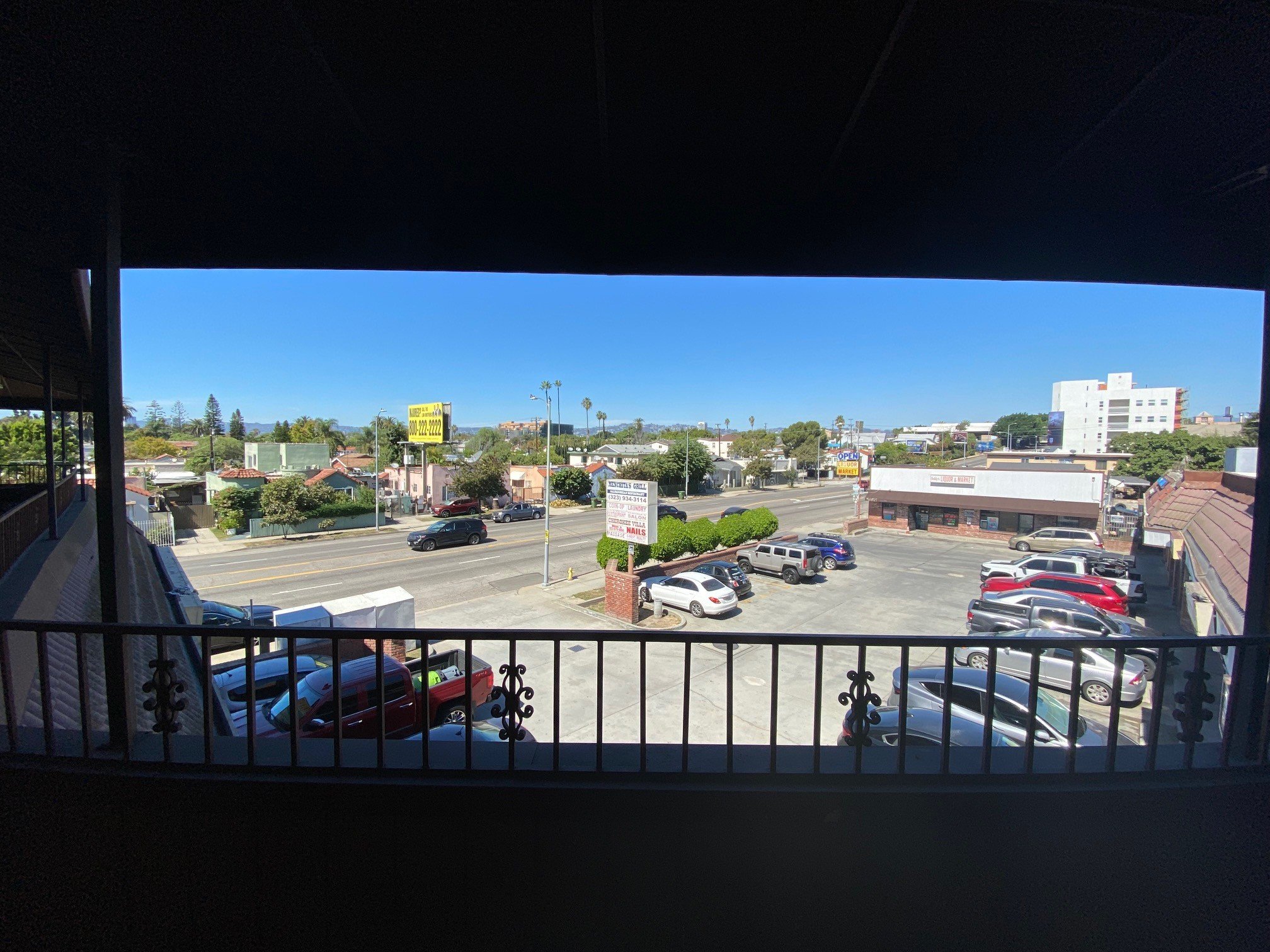 A parking lot with cars and a yellow sign.