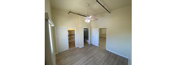 A room with a ceiling fan and light fixture.