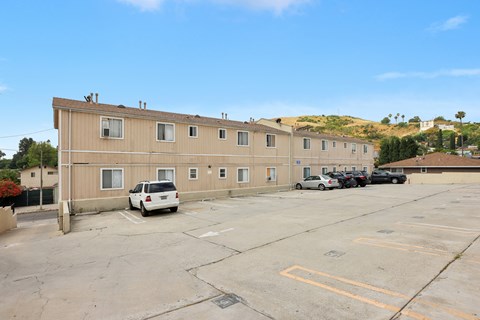 A parking lot with a building in the background.