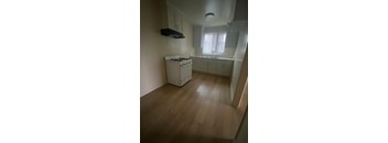 A small kitchen with a stove and a window.