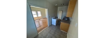 A small kitchen with a washer and dryer.