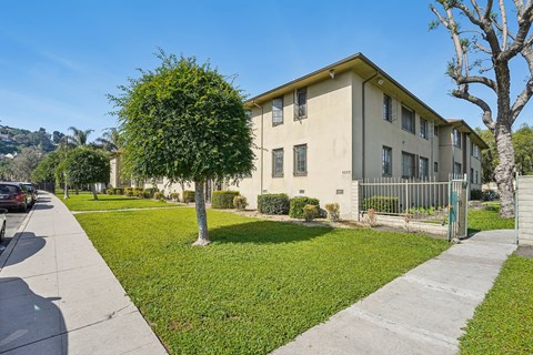 A building with a green lawn in front of it.