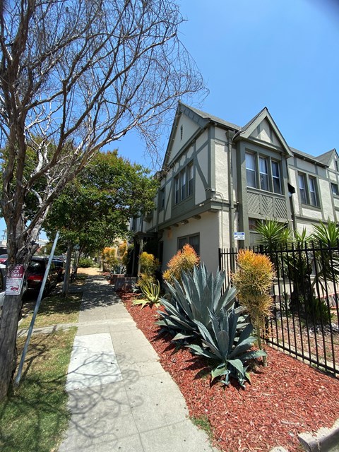 A house with a grey roof and a black fence.