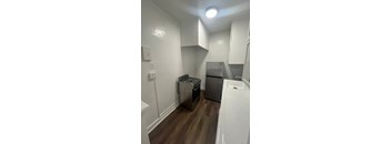 A small kitchen with a sink, stove, and refrigerator.