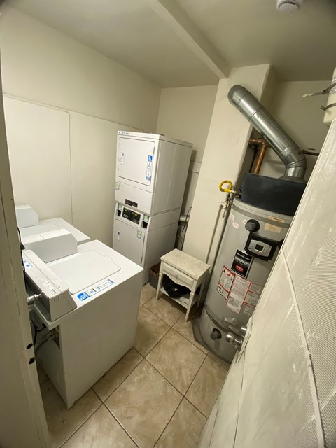 A clean, white-walled bathroom with a washer and dryer.