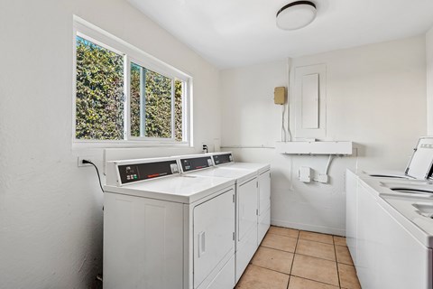 A small laundry room with a washer and dryer.