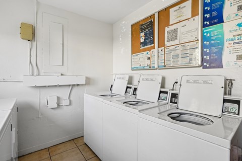A row of washing machines in a laundromat.