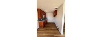 A kitchen with wooden cabinets and a countertop.