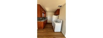 A kitchen with a white fridge and a white stove.
