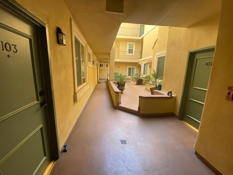 A hallway with doors numbered 103 and 107.