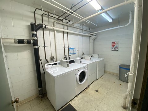 A laundry room with washers and dryers.