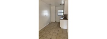 A kitchen area with a sink and a window.