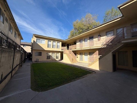 A sunny day at a residential complex with a clear blue sky.