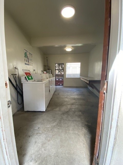 A white kitchen with a sink and a window.
