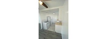 A kitchen with a white stove and refrigerator.