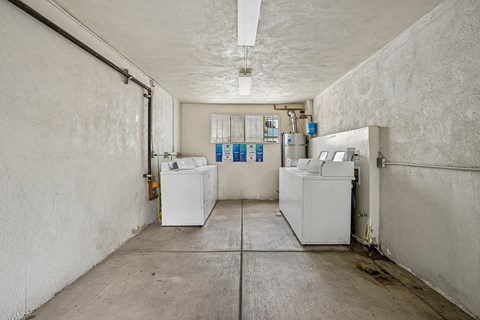 A clean, empty industrial space with white walls and a concrete floor.