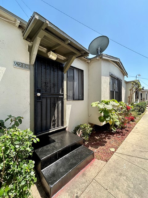 A house numbered 218 has a black door and windows.