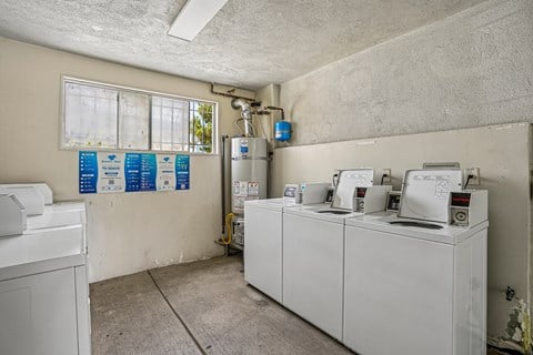 A laundry room with washers and dryers.