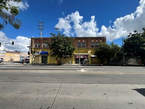 A yellow building is situated on the corner of a street.